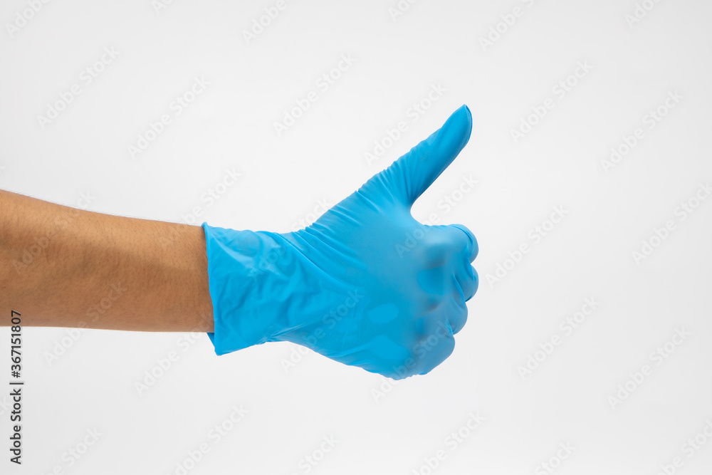Hand of surgeon in blue medical glove showing Ok sign, isolated on a white background Hand of surgeon in blue medical glove showing Ok sign, isolated on a white background