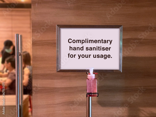 Complimentary hand sanitizer sign at mall entrance during covid-19 coronavirus outbreak. Sanitiser to disinfect their hands as safety measure.