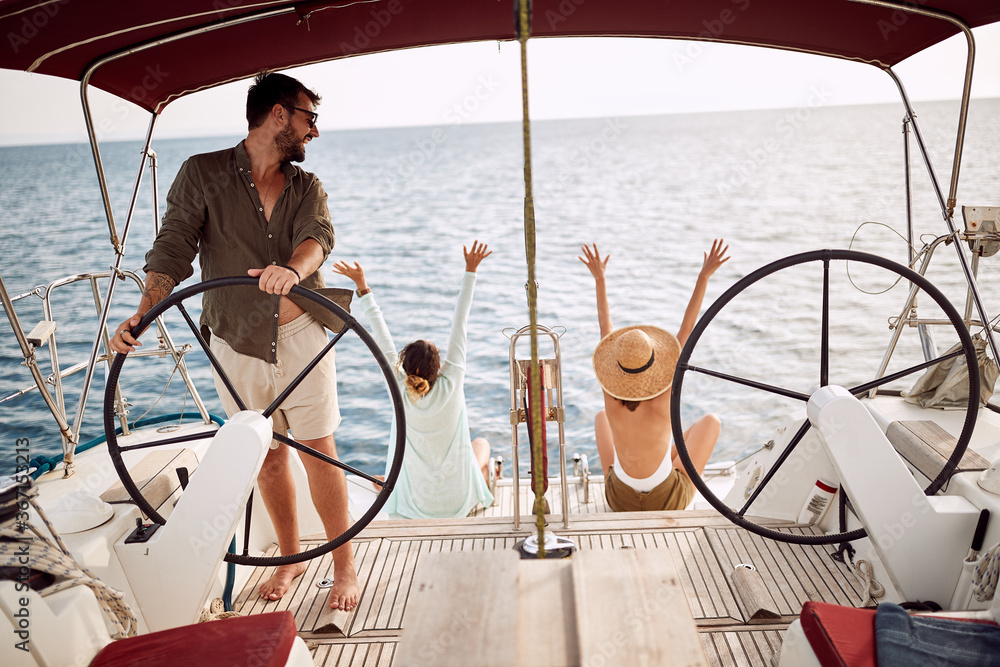 Friends excited by the trip with a yacht Friends excited by the trip with a yacht
