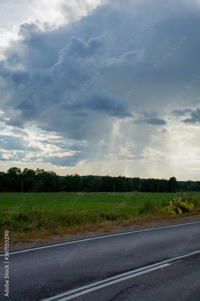 Asphalt road under cloudy sky