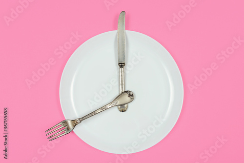 Importance of Eating Regularly. Time to breakfast, plate as a clock shows eight in the morning 