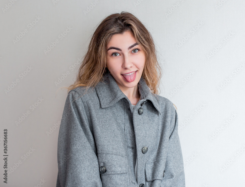 Naughty woman, sticking out her tongue at camera as a sign of disobedience, protest and disrespect. Human emotions, reactions, feelings and attitude Naughty woman, sticking out her tongue at camera as a sign of disobedience, protest and disrespect. Human emotions, reactions, feelings and attitude