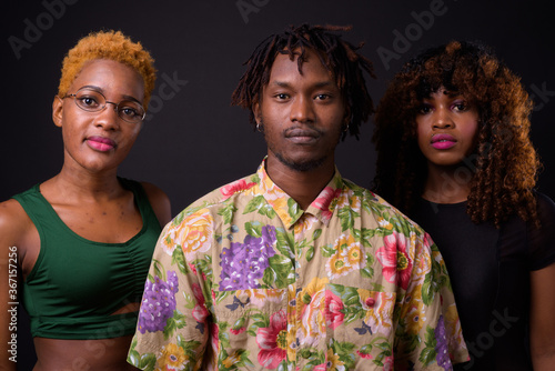 Group of African friends together against black background