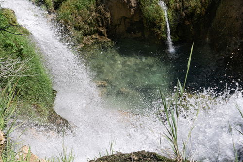 Waterfall falling down to the lake