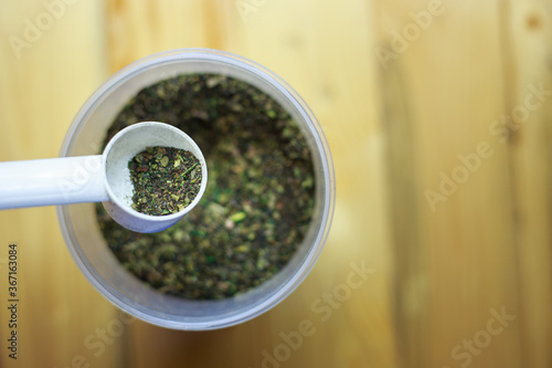 green tea power in a plastic jar