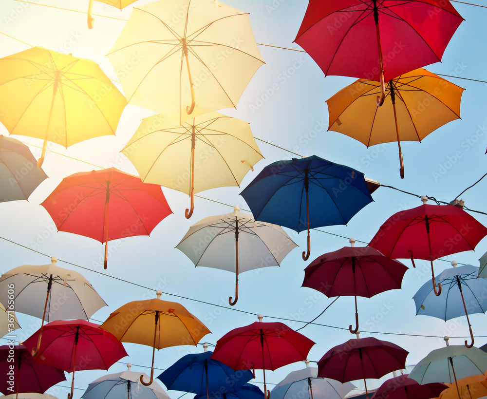 installation of colored umbrellas on stretched cables saves from the bright rays of the sun