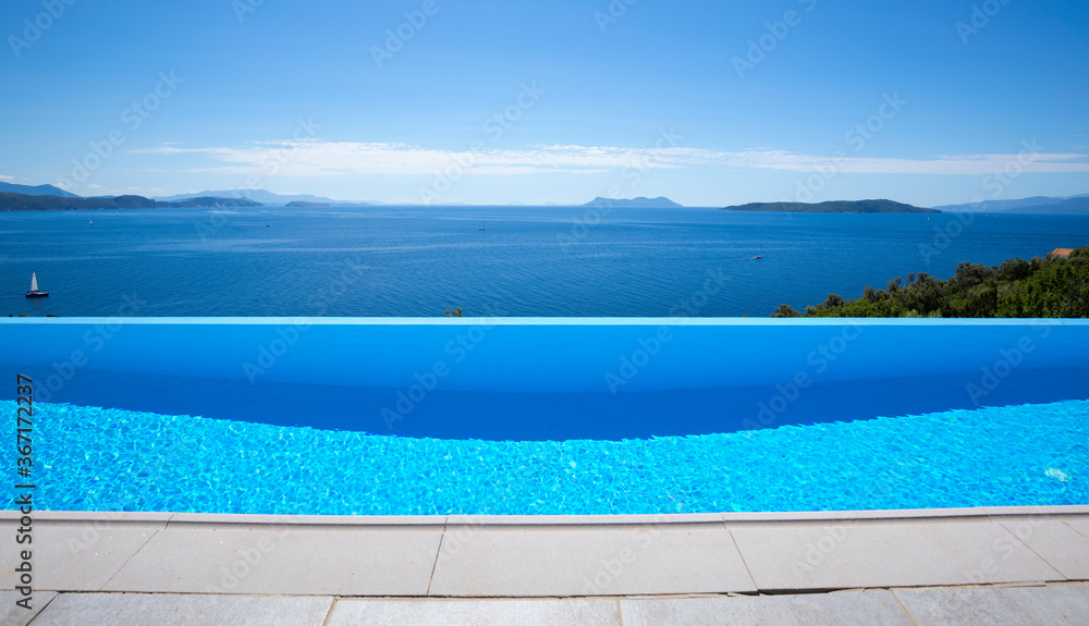 Beautiful blue infinity pool with a sea view