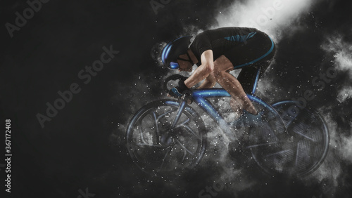 Man racing cyclist in motion on smoke background. Sports banner photo