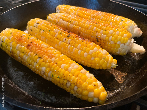 Corn on the Cob Cooking in Cast Iron Skillet