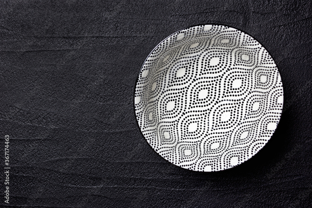 Black and white bowl on a black background Black and white bowl on a black background