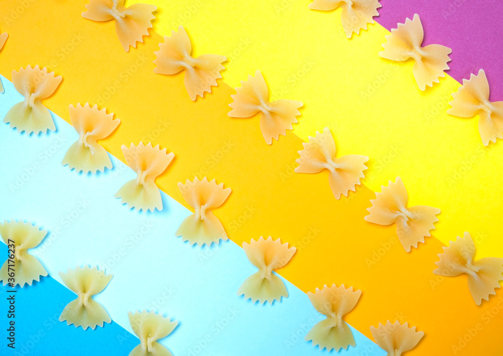 Close up pattern of noodles farfalle also known as bow-tie or butterfly pasta placed on colorful background. Close up pattern of noodles farfalle also known as bow-tie or butterfly pasta placed on colorful background.