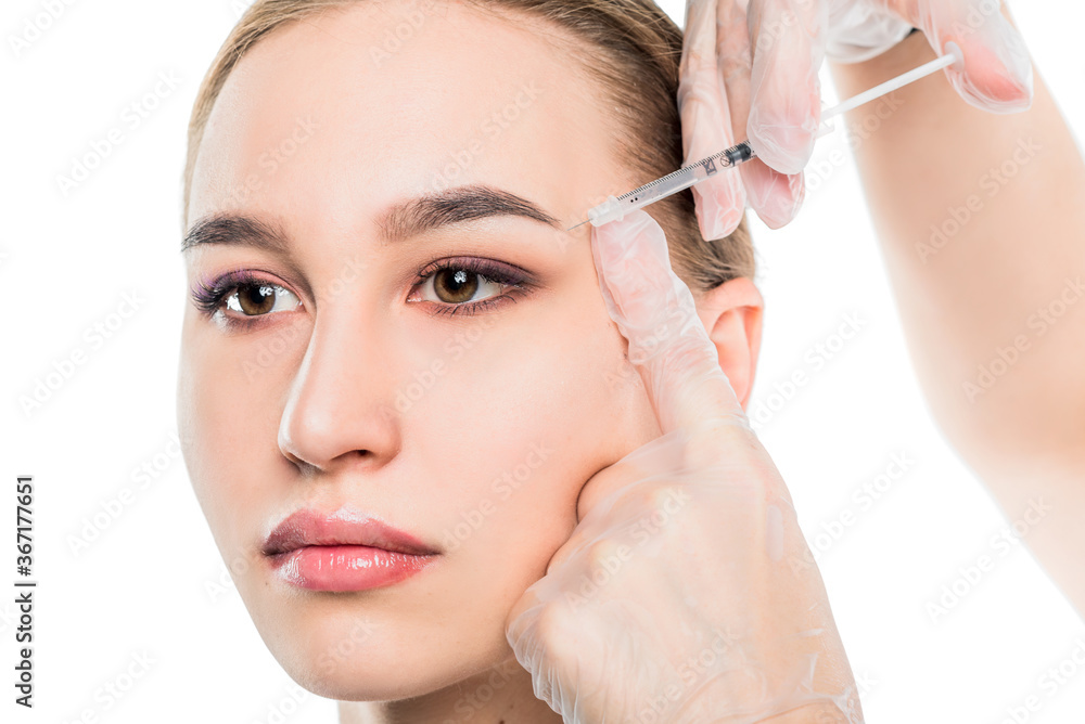 Closeup beautician hands doing facial skin lifting injection to woman's face on isolated white background. Rejuvenation and cosmetology concept