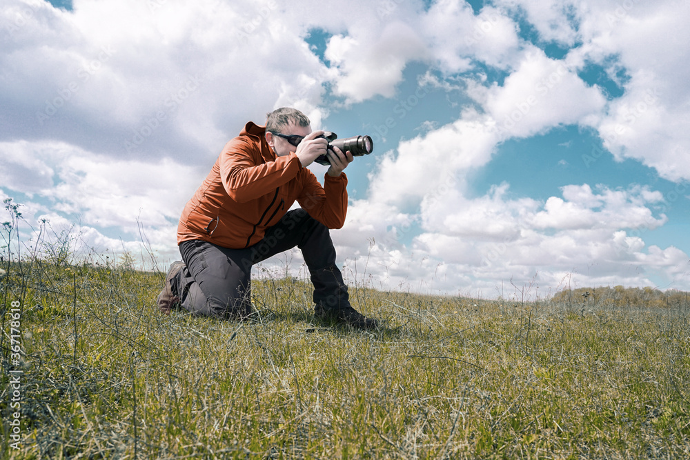 Wild life Nature photographer take a picture in field Wild life Nature photographer take a picture in field
