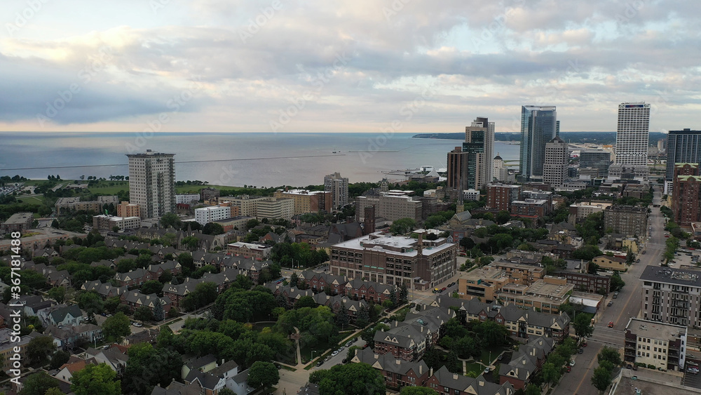 Aerial view of the Milwaukee skyline from the north side of the city, Michigan lake shoreline. Cloudy morning, summertime.