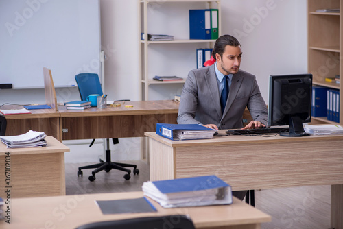 Young male businessman employee working in the office