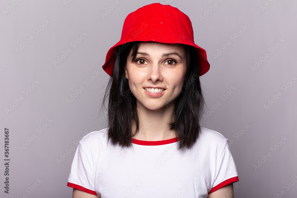 Closeup portrait of a woman in a red panama with a smile on her face