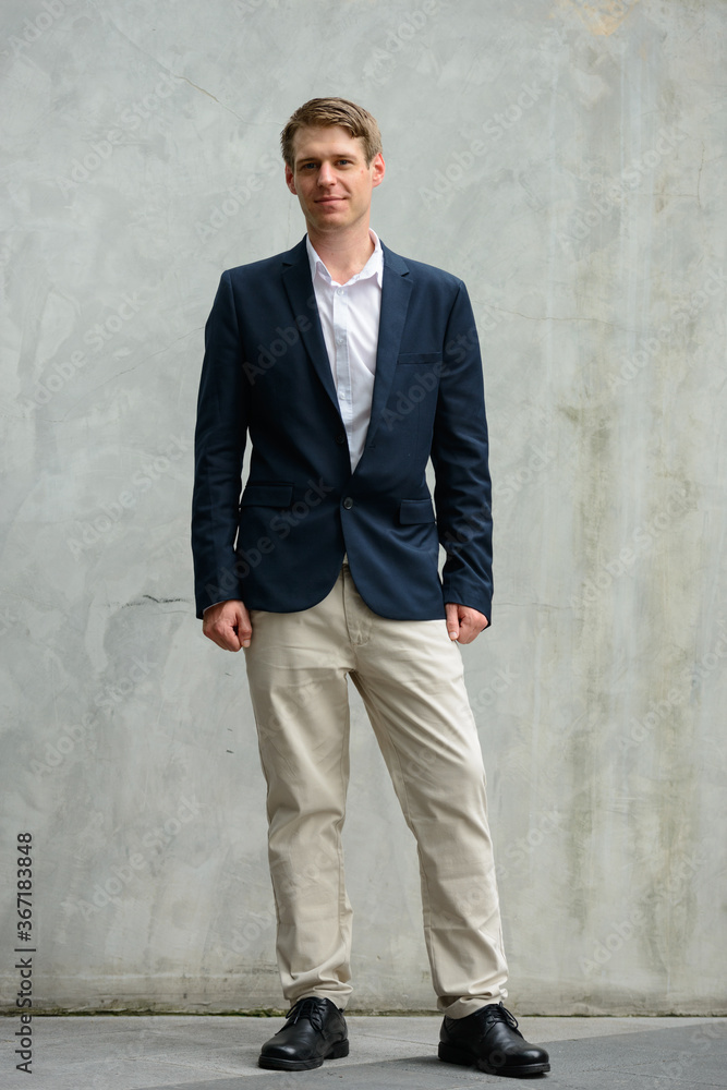 Full body shot of young handsome businessman in suit outdoors Full body shot of young handsome businessman in suit outdoors