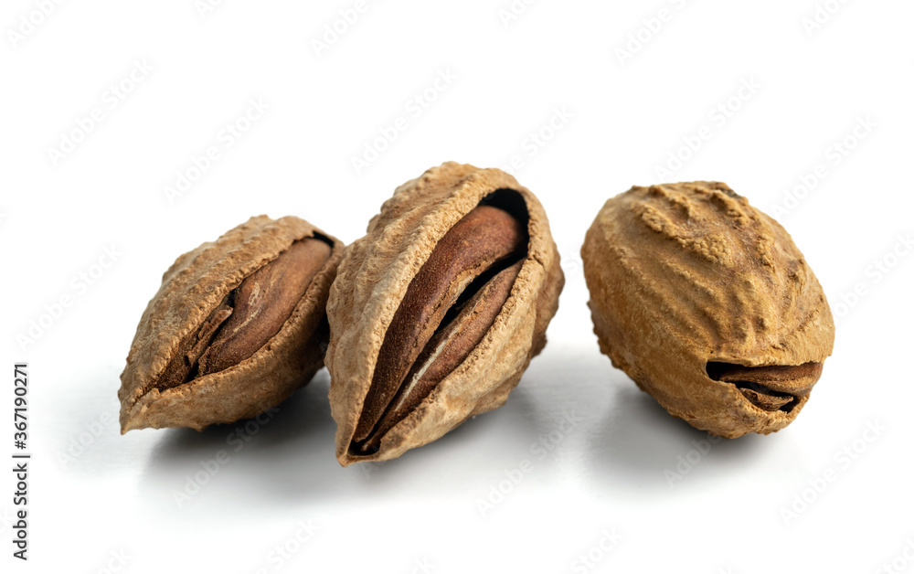 Inshell almonds isolated on a white background. Selected dried inshell almonds. Inshell almonds isolated on a white background. Selected dried inshell almonds.