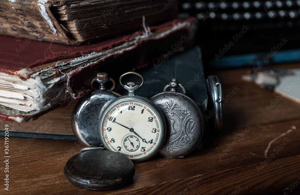 old pocket watch and books