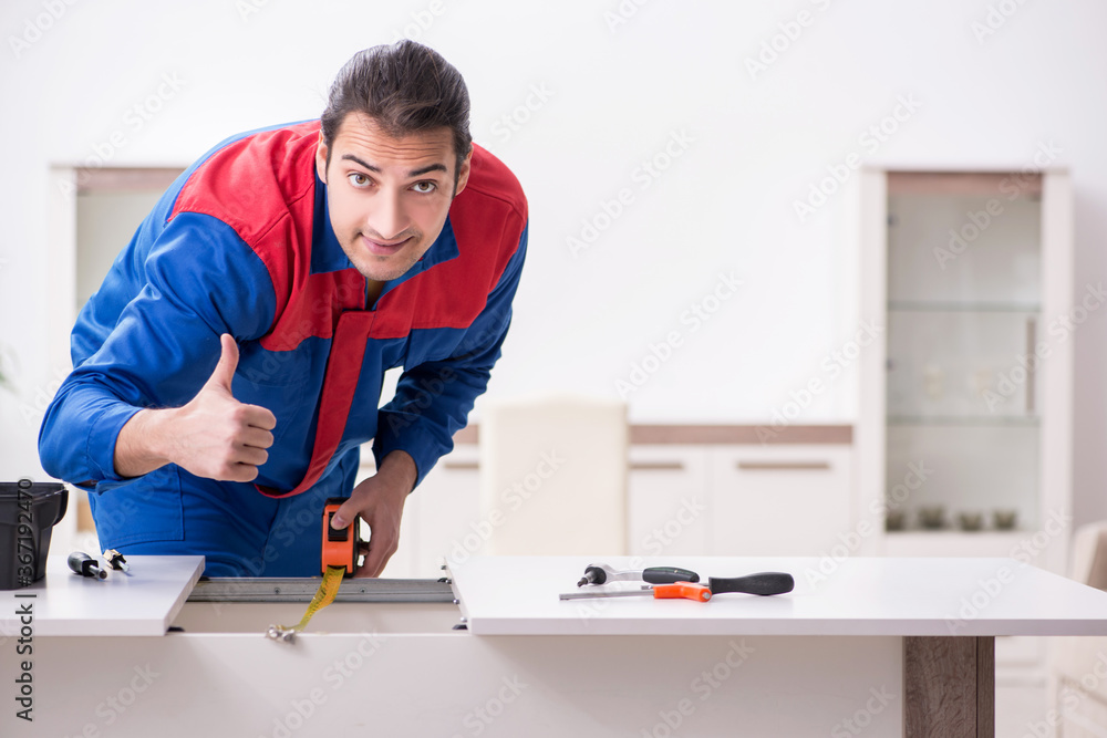 Young male carpenter working indoors Young male carpenter working indoors