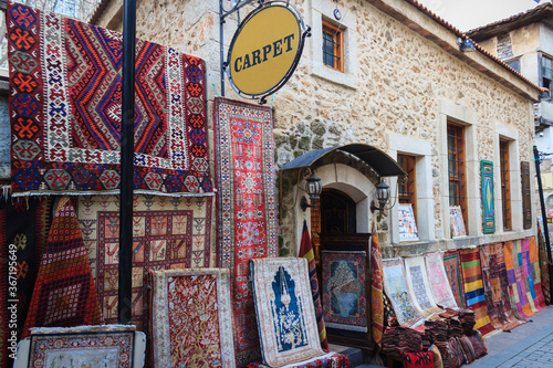 Wallpaper Mural Historical Turkish carpet shop. Old stone carpet store and colorful carpets outside of the shop. Touristic old bazaar in Antalya, Turkey. Torontodigital.ca