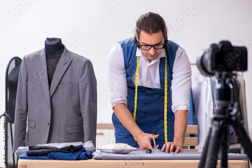 фотографія Young male tailor recording video for his blog