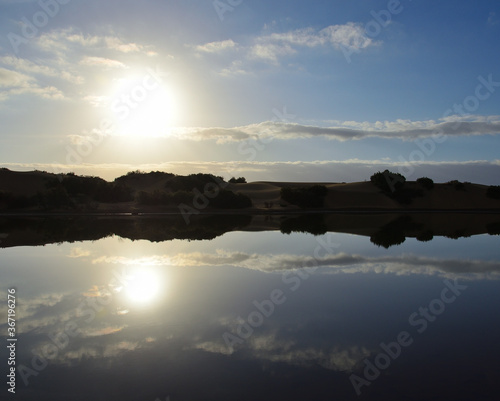 Awesome sunrise with reflections on the lagoon, Maspalomas, south of Gran Canaria, Canary Islands photo