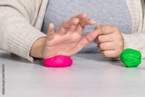 Bild auf Leinwand hand smashing plasticine play dough