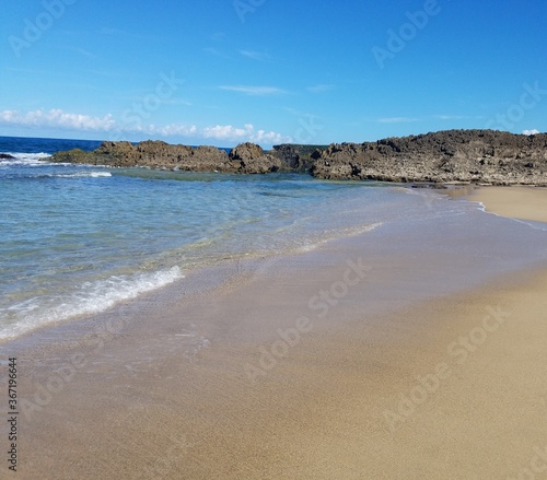 sand and ocean water on beach in Isabela, Puerto Rico