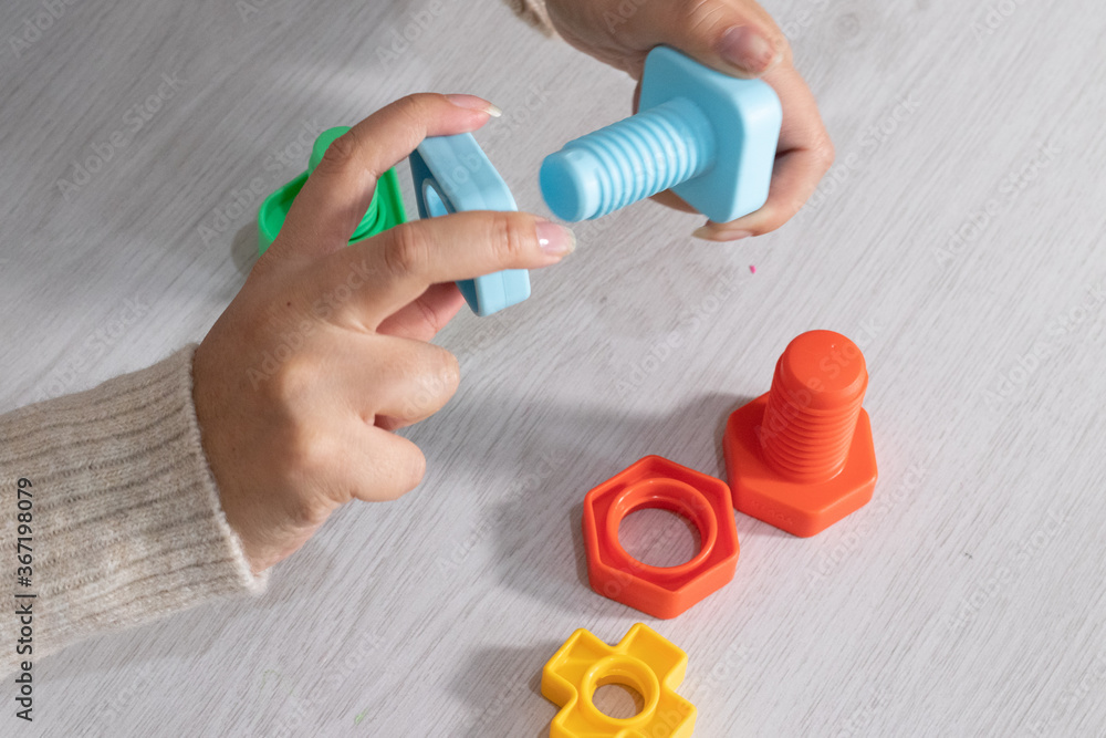 hands with toy screws