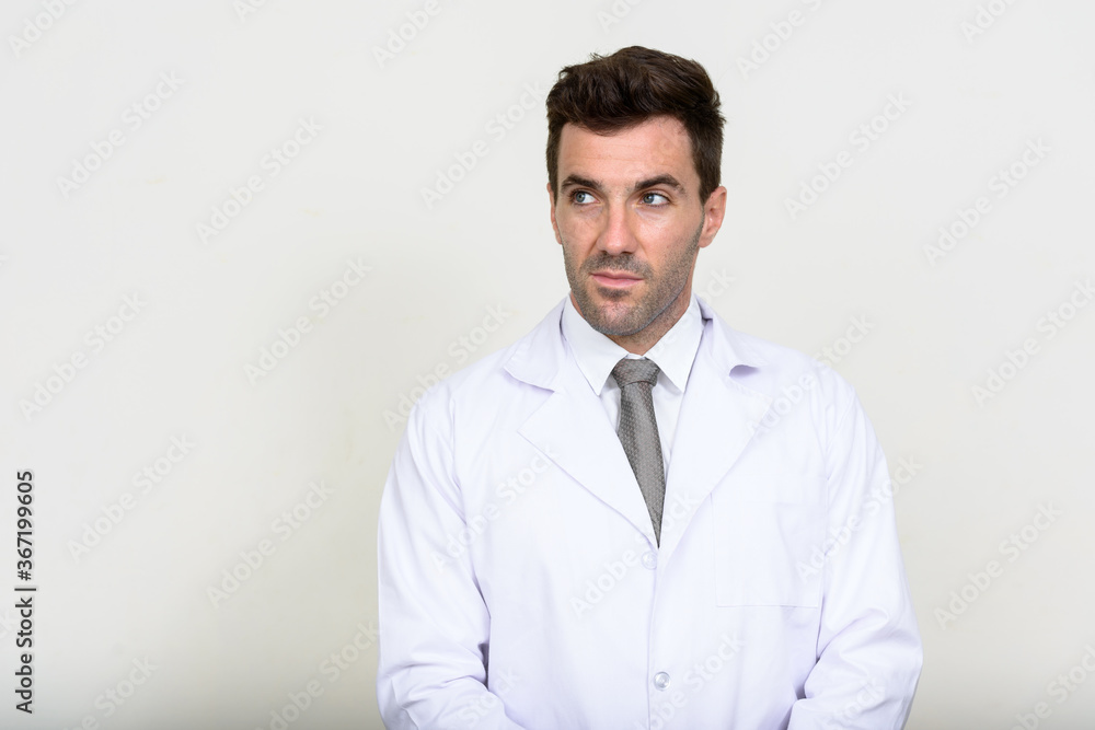 Portrait of handsome Hispanic man doctor thinking Portrait of handsome Hispanic man doctor thinking
