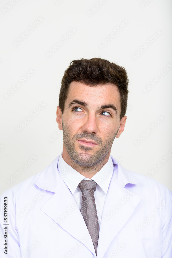 Face of handsome Hispanic man doctor thinking Face of handsome Hispanic man doctor thinking