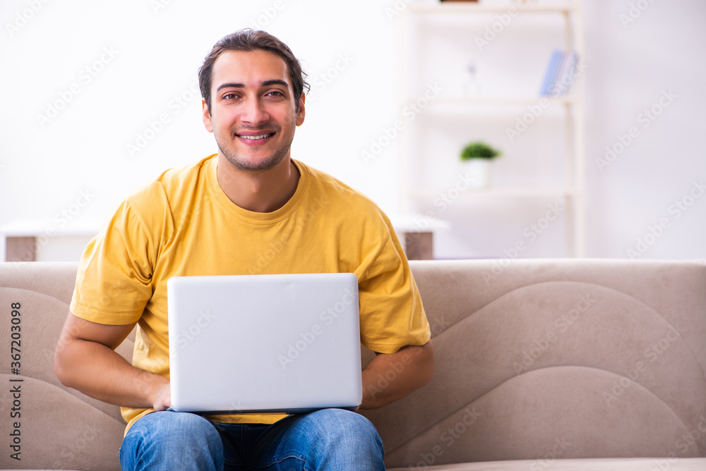 Young handsome man with computer at home Young handsome man with computer at home