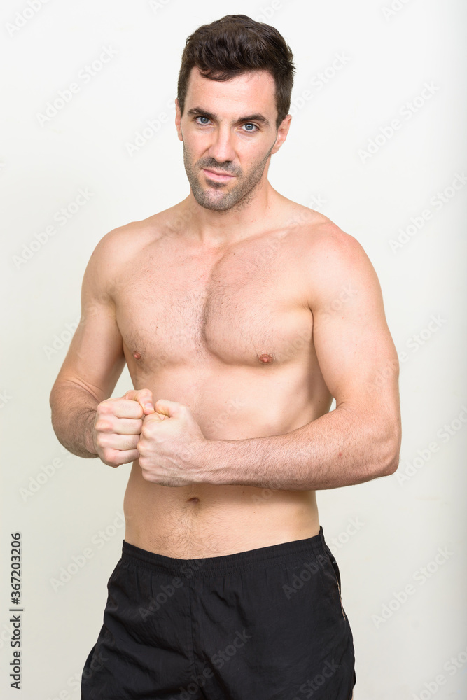 Portrait of handsome muscular Hispanic man shirtless