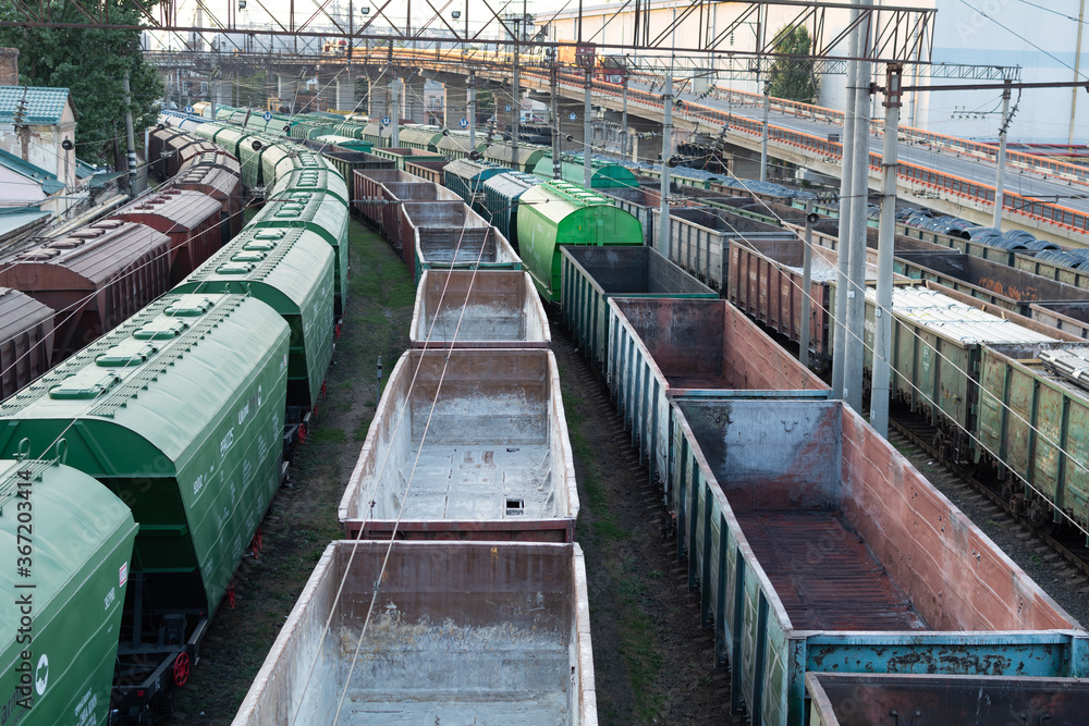 Top view of rail sorting freight station with freight cars, with many rail tracks railroad. Heavy industry landscape. Top view of rail sorting freight station with freight cars, with many rail tracks railroad. Heavy industry landscape.