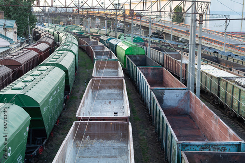 Top view of rail sorting freight station with freight cars, with many rail tracks railroad. Heavy industry landscape.