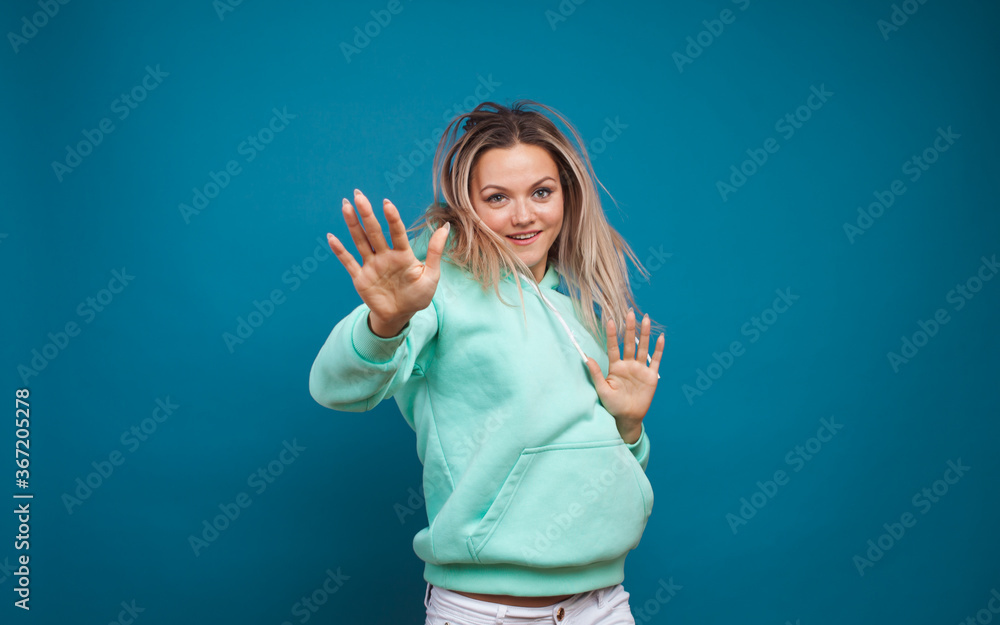 Fototapeta premium Cheerful hipster girl in hoodie and sunglasses.