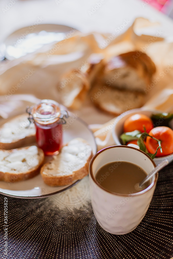 Delicious fresh tasty continental breakfast. Nutritious healthy rustic food. Crispy aromatic bread, jam, fruits. Mediterranean italian lunch. Moorning cooking. Toast with butter. coffee with cream Delicious fresh tasty continental breakfast. Nutritious healthy rustic food. Crispy aromatic bread, jam, fruits. Mediterranean italian lunch. Moorning cooking. Toast with butter. coffee with cream