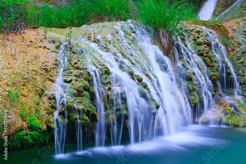 Natural waterfall and lake in Polilimnio area in Greece photo