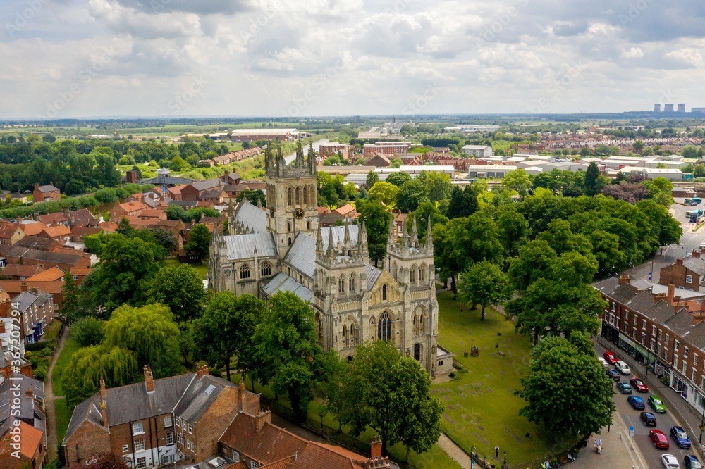 Selby Abbey North Yorkshire England. Drone photograph of the Abbey looking at the North and East side in sun with Selby town behind. Selby Abbey North Yorkshire England. Drone photograph of the Abbey looking at the North and East side in sun with Selby town behind.