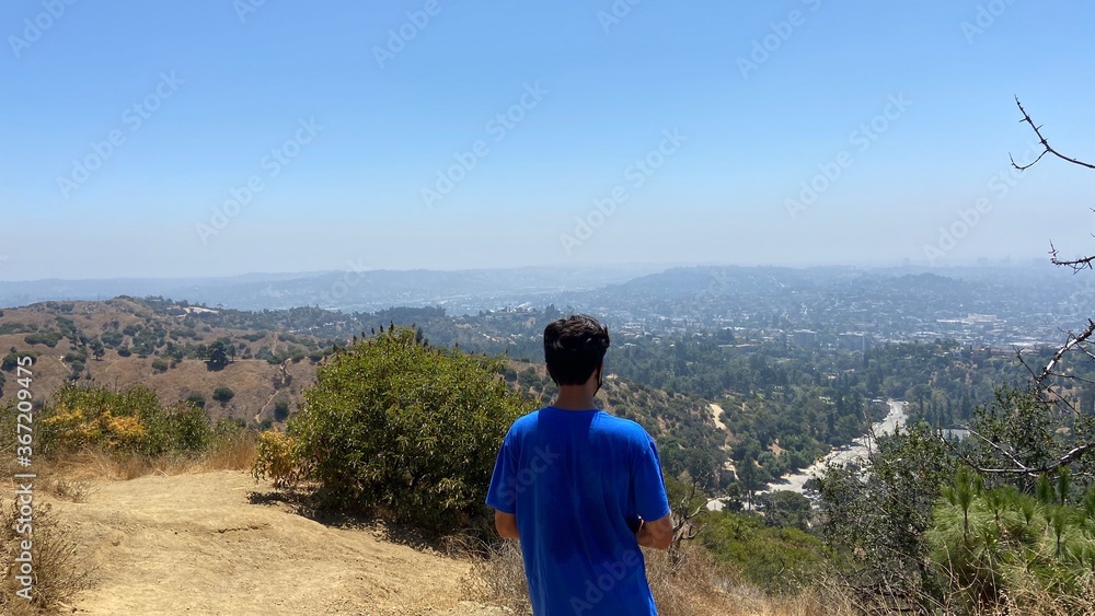 Teenager Hiking over looking city