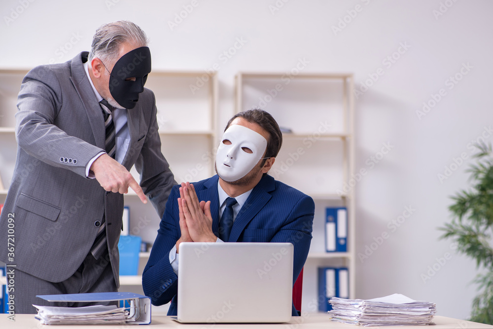 Old boss and young male employee wearing masks Old boss and young male employee wearing masks