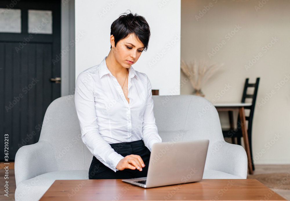 Many stuff to do today in home office. Business woman working from home using her laptop Many stuff to do today in home office. Business woman working from home using her laptop