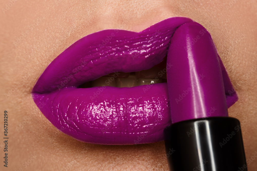 Obraz premium Plump lips with lilac lipstick. Macro photography