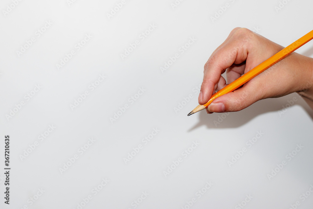 Hand Holding a Pencil to Write Hand Holding a Pencil to Write