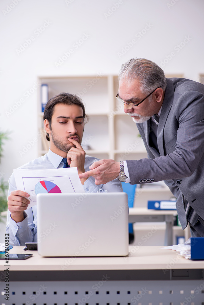 Two accountants working in the office Two accountants working in the office