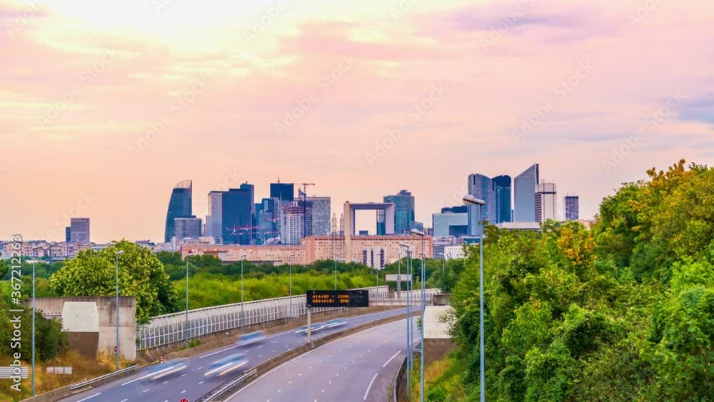 4k timelapse of skyscrapers of Paris business district La Defense on a cloudy summer day and the traffic on highway A14. From houilles, west of Paris, France.Camera fixed position 4k timelapse of skyscrapers of Paris business district La Defense on a cloudy summer day and the traffic on highway A14. From houilles, west of Paris, France.Camera fixed position