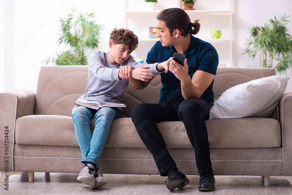 Father and son in exam preparation concept Father and son in exam preparation concept