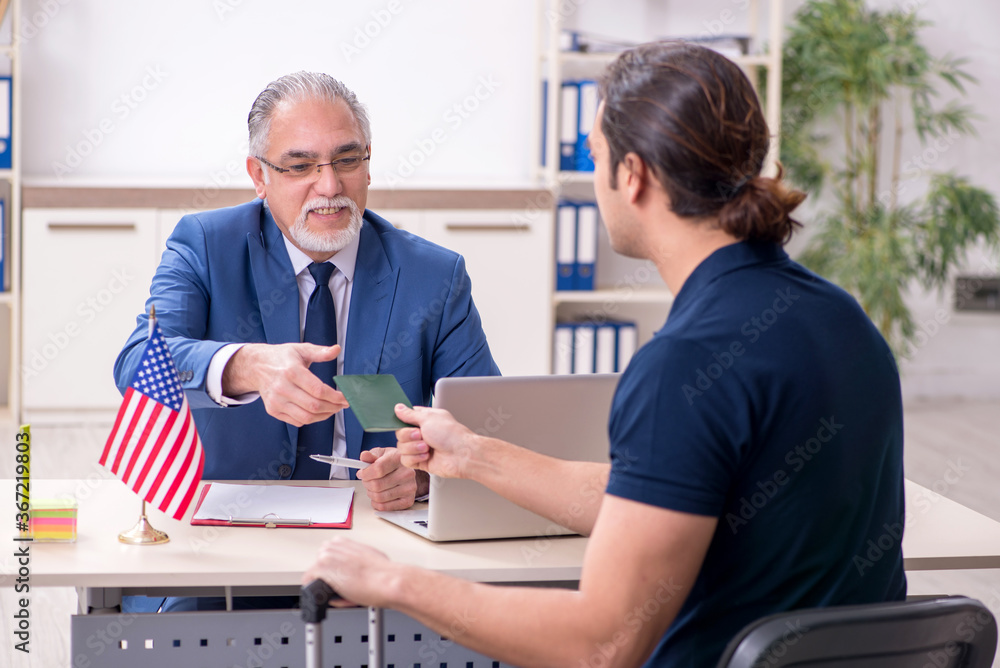 Young man visiting embassy for visa application Young man visiting embassy for visa application