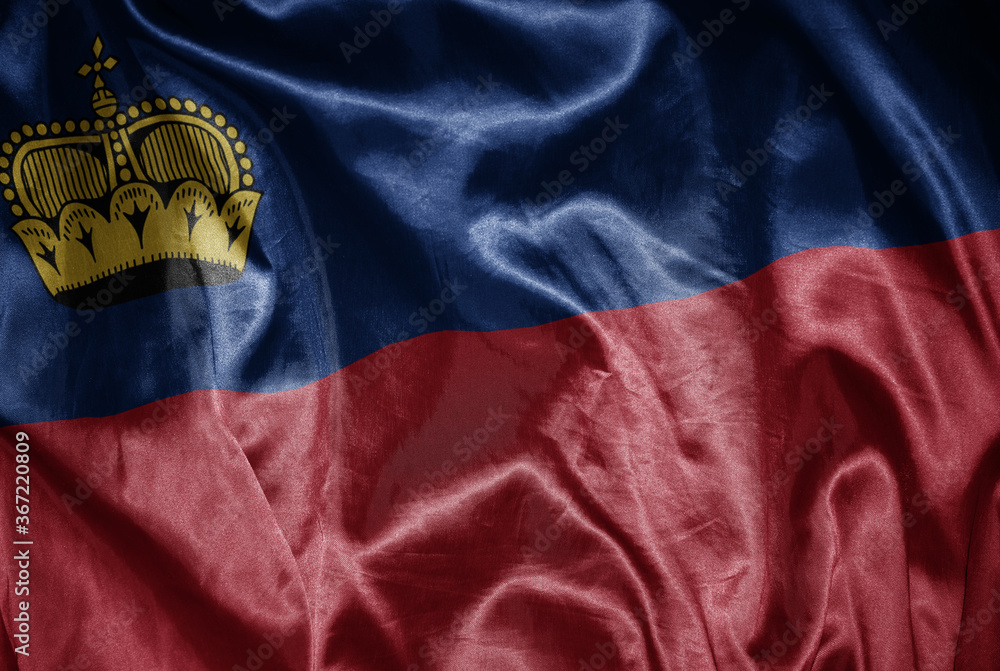 colorful shining big national flag of liechtenstein on a silky texture.